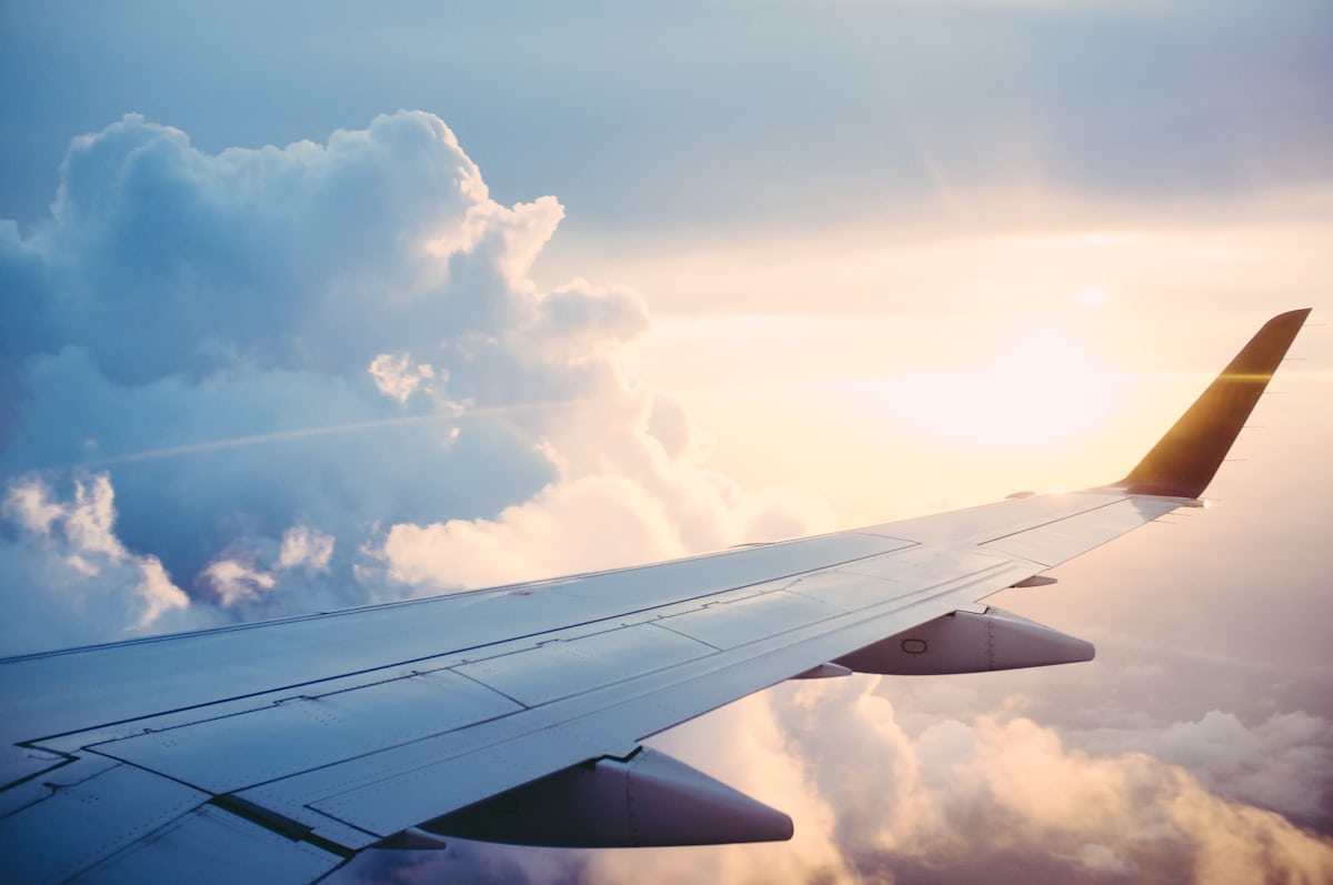 Aerospace and UAV localization — an airliner wing in flight above the clouds